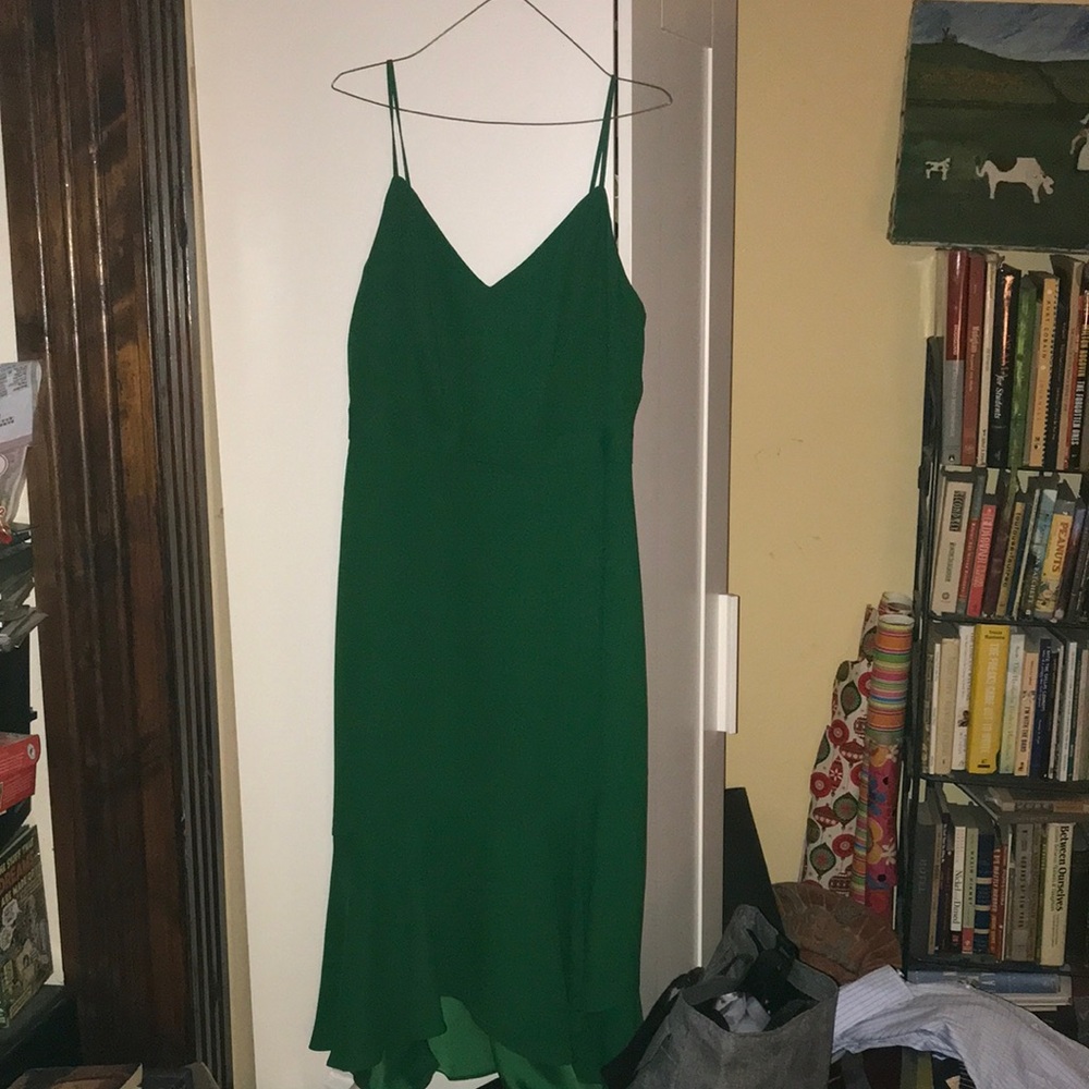 Green slip dress with adjustable straps and layered front hem; perfect condition